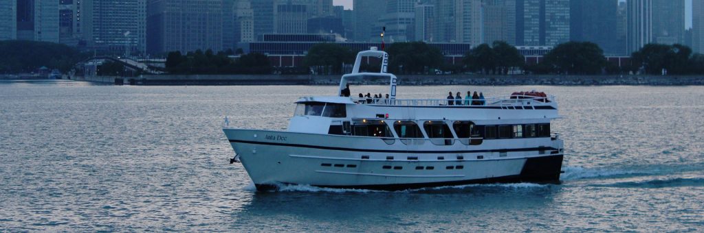 Chicago private yacht charter Anita Dee I on the water at dusk.